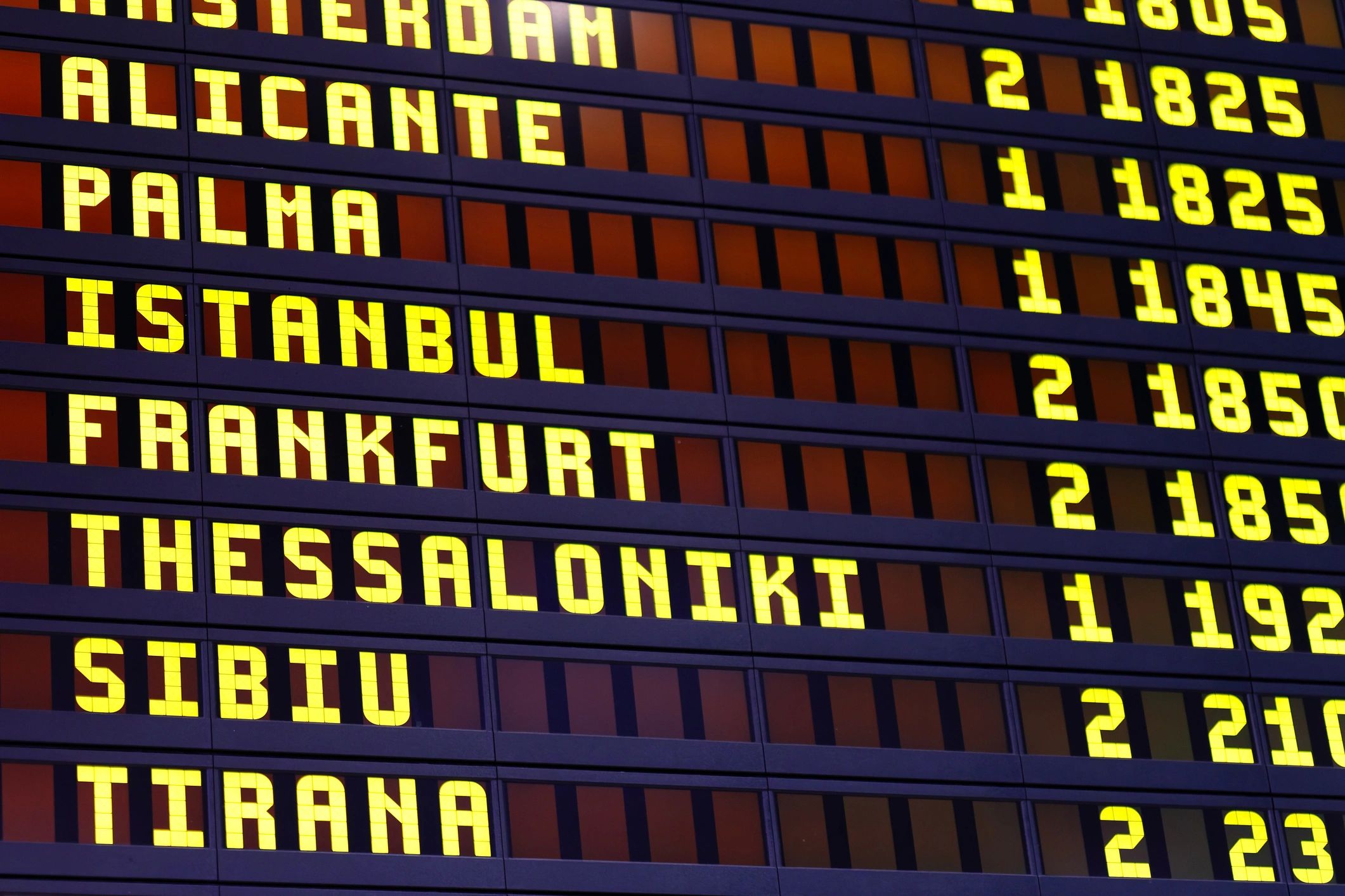 Airport departure board with flight schedules